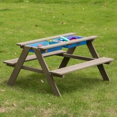 a picnic table with two benches in the grass