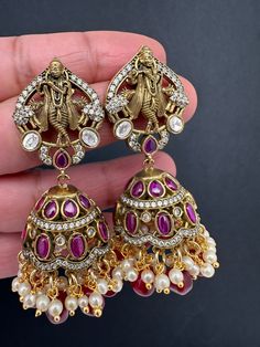 Krishna Jhumki Earrings pushback earringsColor : VictorianSize : Length : 2.5 Inches; Weight : 18grams eachStones : Red Green Stones Pearls Beads Ruby Meenakari Jhumkas For Festivals, Bollywood Style Ruby Chandbali Jhumkas, Bollywood Style Red Ruby Earrings, Ruby Meenakari Jhumkas Temple Jewelry, Ruby Meenakari Jhumkas For Gift, Ruby Meenakari Temple Jewelry Jhumkas, Diwali Ruby Meenakari Jhumkas, Heavy Ruby Jhumkas For Festive Occasions, Heavy Ruby Traditional Jhumkas