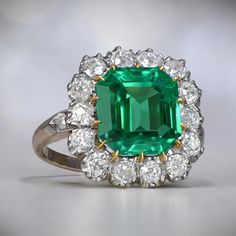 An Impressive Cluster Ring That Features A Lively 4.55 Carat Natural Colombian Emerald Cut Emerald. Colombian Emerald Ring, Estate Diamond Jewelry, European Cut Diamond Ring, Columbian Emeralds, Emerald And Diamond Ring, Gia Certificate, Gemstone Engagement, Colombian Emeralds, 18k Yellow Gold Ring