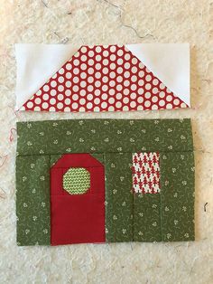 a patchwork house with red and green accents