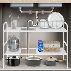 a shelf with pots, pans and other kitchen utensils on top of it