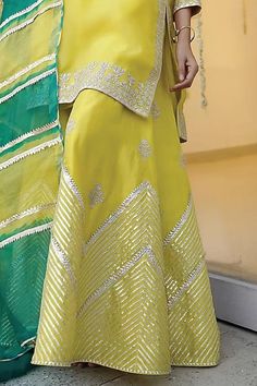 Lime yellow kurta in organza base with embroidery details. Paired with a matching chanderi sharara pant and a leheriya dupatta.
Components: 3
Pattern: Embroidered
Type Of Work: Zari
Neckline: Notched
Sleeve Type: Three-quarter
Fabric: Chanderi, Organza
Color: Yellow
Other Details: 
Attached lining
Kurta length: 38 inches
Model Height: 5ft 5inches, wearing size S
Occasion: Mehendi and Haldi - Aza Fashions Leheriya Dupatta, Yellow Kurta, Sharara Pants, Kurta Sharara Set, Kurta Sharara, Lime Yellow, Sharara Set, Embroidery Details, Set For Women