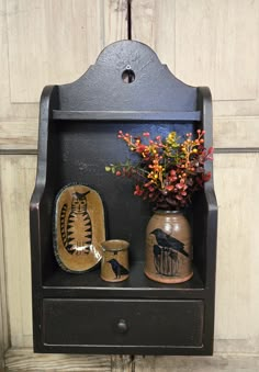 an old wooden shelf with vases and other items