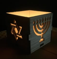 a lit up box with an image of a menorah on it