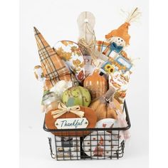 a basket filled with lots of different types of thanksgiving items and decorations on top of a white background