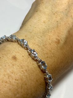 "This Blue Aquamarine with tiny genuine diamonds. The bracelet is very lively and bright. Gorgeous for that \"something blue\" for weddings. The stones colors and well matched. The sterling silver is plated with rhodium to protect the bracelet from tarnish and give the appearance of white gold. 8 inches for a larger wrist. All jewelry is shipped in a nice gift box. Check out our over a THOUSAND great reviews Engraving is $4 per letter and is not always perfect depending on the piece. It can take Fine Sterling Silver Bracelet With Sparkling Stones, Sterling Silver Bracelet With Sparkling Stones, White Gold Diamond Bracelet With Sparkling Stones, Dazzling Sterling Silver Bracelets With Diamond Accents, Sterling Silver Bracelet With Prong Setting, Sterling Silver Bracelet With Sparkling Stones For Anniversary, Elegant Blue Sterling Silver Bracelet As Gift, Fine Jewelry Sterling Silver Bracelet With Prong Setting, Elegant Blue Sterling Silver Bracelet For Gift