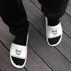 Step into a world of style and comfort with our Black Skull White Slides for Men. These striking slides are designed to make a bold fashion statement while ensuring your feet stay comfortable all day long. The cushioned upper strap and textured footbed make these slides an excellent choice for the season's activities. 🦴 Cushioned Comfort: Our men's slides feature a cushioned footbed that provides superior comfort with each step. Whether you're relaxing at home or heading out, these slides are p Textured Footbed Slip-on Slides For Streetwear, White Slides For Streetwear, Non-slip Slip-on Slippers For Streetwear, Slip-resistant Open Toe Slides For Streetwear, Casual Slides For Streetwear With Rubber Sole, Casual Slides With Rubber Sole For Streetwear, Casual Streetwear Slides With Rubber Sole, Streetwear Open Toe Slides With Textured Footbed, Casual Slip-resistant Slides For Leisure