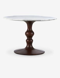 a round table with a marble top and wooden base on an isolated white background for use as a centerpiece