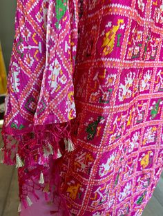 Lovely patola printed, full size dupattas in crepe silk material. The dupattas comes with tassels at the ends. Can be worn on Kurtis, gowns and lehengas. The dupattas are crushed and can be draped easily. Comes in 4 designs. Festive Silk Kurta With Ikat Print, Festival Kurta With Tassels, Bollywood Style Salwar Kameez With Tassels For Navratri, Navratri Chanderi Dupatta With Tassels, Festive Bollywood Salwar Kameez With Tassels, Bollywood Style Salwar Kameez With Tassels For Festive Season, Bollywood Style Festive Salwar Kameez With Tassels, Bohemian Pink Traditional Wear With Printed Motifs, Pink Bohemian Traditional Wear With Printed Motifs