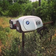 an old fashioned mailbox sitting in the middle of a field