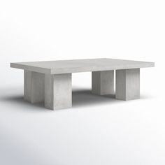 a concrete table sitting on top of a white floor