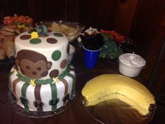 there is a cake with a monkey on it and other food items in the background