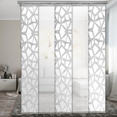 a room with white furniture and glass doors