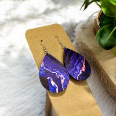 Beautiful Purple Geode Earrings!  These are lightweight. The pendant measures 2 inches long. A perfect length for most!  The wood is printed/ painted on both sides of the earring, then laser cut into a tear drop shape for a unique finish.  Handmade with hypoallergenic hardware with three different color options-  Silver , Bronze , & Rose Gold  These are perfect for all gem lovers!  Great gift for birthdays, moms, teachers, daughters, wives.  *Please message me with any questions/ concerns! I wil Single Purple Drop Earring, Purple Single Drop Earring, Hypoallergenic Purple Dangle Teardrop Earrings, Purple Earrings For Pierced Ears Gift, Purple Plug Earrings For Pierced Ears As A Gift, Purple Drop Earrings With Ear Wire, Purple Plug Earrings As Gift, Adjustable Purple Earrings, Nickel Free Purple Teardrop Earrings