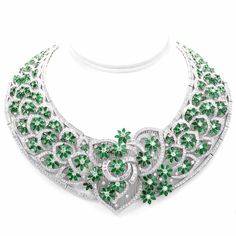 This captivating vintage necklace is masterfully handcrafted in solid 18K white gold, weighing approximately 304.0 grams. The entire openwork lace pattern surface is embellished with emerald flowers and diamond buds and stems to produce this breathtaking floral spray neck adornment. Some 1580 sparkling round-faceted diamonds and 59 genuine baguette diamonds.All floral profiles are further enhanced with immaculately milled grained borders.Featuring a well-concealed tongue-in-groove secu Luxury Round Emerald Necklace With Gemstone Accents, Luxury Traditional 22k Gold Emerald Necklace, Formal Emerald Necklace With Intricate Design, Heart Shaped Diamond Pendant, Pave Heart Necklace, Gold Collar Necklace, Antique Necklaces, Necklace With Diamond, Horseshoe Pendant