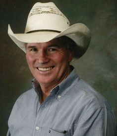 a man wearing a cowboy hat and smiling