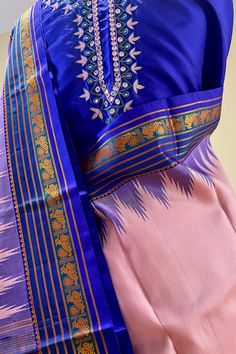 Fabric : Pure Kanjivaram Silk Type : Thread work korvai contrast Body Color : Light lotus pink Border Color : Bluish purple Blouse Color: Bluish purple Pallu Color: Bluish purple Approximate height - 46 - 52" Approximate weight - 1.4 lbs Approximate Length - 6.25 - 6.50 mtrs (inclusive of blouse length) Technique on the blouse : Aari and mirror work Saree comes with fall, picot and tassels done when applicable. Blouse piece is cut. Kindly Note : The colors you see on your device may vary due to Traditional Pink Cotton Silk Kurta, Designer Purple Kurta With Cutdana Details, Transitional Silk Pink Kurta, Transitional Pink Silk Kurta, Transitional Pink Cotton Silk Set, Traditional Drape Purple Kurta With Cutdana, Purple Kurta With Cutdana For Navratri, Pink Silk Anarkali Set For Transitional Season, Designer Pink Tussar Silk Anarkali Set