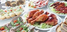 a table topped with plates filled with different types of meats and veggies