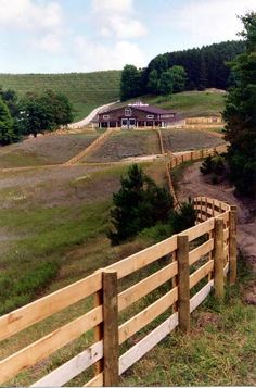 a wooden fence on the side of a hill