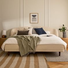 a large bed sitting on top of a wooden floor