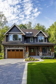 a large house with two garages and lots of windows on the front of it