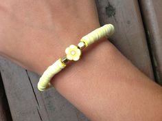 This is a yellow flower bracelet! Cheap Yellow Flower Bracelet, Adjustable Bracelet With Flower Decoration For Spring, Spring Bracelets With Adjustable Flower Decoration, Adjustable Flower Bracelets For Spring, Adjustable Spring Bracelet With Flower Decoration, Yellow Flower-shaped Jewelry For Spring, Casual Flower-shaped Jewelry For Spring, Casual Flower-shaped Spring Jewelry, Spring Yellow Flower-shaped Jewelry