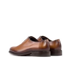 Often considered the most formal men's shoe available, the Wholecut features closed channel lacing and is made from a single cut of leather. The sleek design and limited stitching make for an elegant and highly sought-after style. The Details: Materials: cognac box calf Sole: cognac leather sole with rubber buttons injections Last: Zurigo - Rounded toe for traditional English Look What is Fast Lane? Fast lane is our new experimental 7 day made to order collection, an ambitious never been heard o Cognac Leather Cap Toe Shoes For Derby, Cognac Leather Shoes With Brogue Detailing For Semi-formal Occasions, Timeless Brown Lace-up Shoes With Leather Sole, Luxury Brown Almond Toe Derby Shoes, Luxury Brown Almond Toe Derby, Timeless Brown Derby Shoes For Office, Timeless Brown Oxfords For Formal Occasions, Cognac Oxfords With Leather Sole For Derby, Cognac Oxfords With Brogue Detailing And Almond Toe