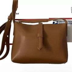 Crew Parker Crossbody Bag Is Adorable And Perfect For Both Casual Days And Travel. With A Width Of Approximately 8 Inches, Height Of 6 Inches, And Depth Of 1.5 Inches, It Is The Perfect Size For Your Everyday Essentials. The Exterior Material Is Made Of Smooth Leather In A Neutral Tan Color, And The Handle/Strap Is Adjustable. The Bag Features A Zip And Magnetic Snap Closure, With Some Expected Wear On The Gold Metal Zipper And Snap Halves. New With Tags. Brown Box Bag With Single Shoulder Strap For Everyday, Tan Crossbody Shoulder Bag With Adjustable Strap, Leather Shoulder Bag With Single Strap For Errands, Tan Satchel Shoulder Bag With Adjustable Strap, Leather Pouch Shoulder Bag With Single Strap, Leather Single Strap Pouch Shoulder Bag, Leather Single Strap Shoulder Pouch, Tan Satchel With Adjustable Strap, Classic Crossbody Shoulder Bag For Errands