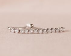 "This is an original design by me! I've created this beautiful bracelet using Swarovski crystals set in a row for a delicate and dainty look. This bracelet is easily adjustable by moving the slide up or down on the bracelet chains. This is the perfect gift for your flower girl . . . one that she'll enjoy long after your special day! Crystal focal measures 2.5\" long and 3/16\" wide. Child's bracelet expands to approximately 7.5\" to fit over hand. Please message me with any questions! Thank you Adjustable Dazzling Tennis Bracelet For Anniversary, Sparkling Diamond White Crystal Bracelet As Gift, Adjustable Diamond Bracelet With Rhinestones For Wedding, Crystal Tennis Bracelet With Diamond Accents As Gift, Diamond Crystal Bracelet With Sparkling Stones As Gift, Crystal Diamond Bracelet As Gift, Diamond Jubilee Bracelet In Crystal For Gift, Crystal Tennis Bracelet With Jubilee Design, Diamond White Crystal Bracelet With Sparkling Stones As Gift