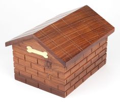 a wooden dog house with a bone on the top and bottom part inlayed to it's roof