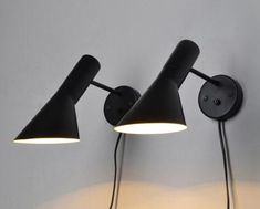 two black lamps are on the wall next to each other