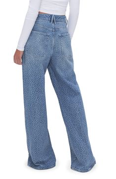 Glistening crystal embellishments dance in the light on these low-stretch wide-leg jeans featuring a faded indigo wash. 33" inseam; 25" leg opening; 13" front rise; 15 1/2" back rise (size 8) Zip fly with button closure Five-pocket style 79% cotton, 20% recycled cotton, 1% elastane Machine wash, tumble dry Imported Black Owned/Founded Embellished Jeans, Good American, Khloe Kardashian, Leg Jeans, Powerful Women, Wide Leg Jeans, Women Empowerment, Fashion Brand, Wide Leg