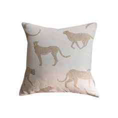 a white and gold pillow with leopards printed on it's side, against a white background