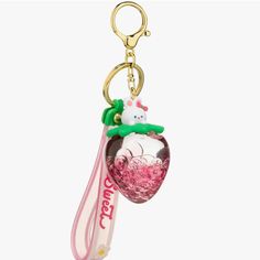 a keychain with a hello kitty charm hanging from it's side