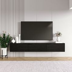 a living room with a large flat screen tv mounted to the side of a wall