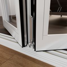 an open sliding door on the side of a house with wood flooring and white walls