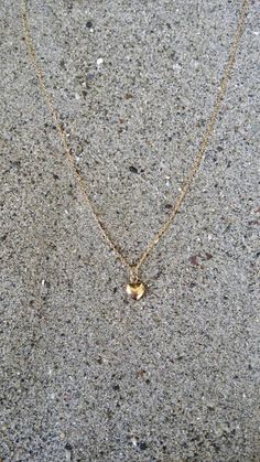 "Beautiful. Delicate Tiny gold 6mm (0.23 inches) puffed heart hangs delicately from a gold fill chain. The heart is puffed on both sides and hollow in the center. Made from high quality tarnish resistant gold fill. Shown here in 16\" length. *If you are unsure of the length you need, or would like to wear this item at different lengths, we now offer an adjustable length option! You can add an adjustable end to your necklace using this link: https://www.etsy.com/listing/791277751/necklace-extensi Delicate Gold Heart Charm Necklace, Everyday Gold Heart Necklace 14k Gold Filled, Everyday 14k Gold-filled Heart Necklace, Gold Heart Pendant Necklace For Everyday, 14k Gold-filled Heart Necklace With Heart Charm, Dainty 14k Gold Filled Heart Necklace, Everyday Gold Necklaces With Heart Beads, Delicate Gold Heart Pendant Charm Necklaces, Delicate Gold Charm Necklaces With Heart Pendant