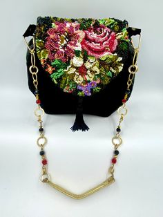 "\"THE BUNCH OF FLOWERS\" The individual design, made of natural, black, Spanish suede and varnished natural leather. The taffeta lining. The flap of the bag made of leather beautifully embroidered with glass beading with the theme of flowers, decorated with tail. The jewelry strap made of brass, Swarovski crystals and leather in the gold color.  Measurements 25X27X4,5cm Length of chain: 82cm This handbag is unique and one of its kind. You can take this handbag for a small party,official event or to a club if you have such wish.OOAK" Unique Evening Clutch Bag, Unique Handmade Evening Bags, Designer Handmade Evening Shoulder Bag, Luxury Embellished Shoulder Bag, Luxury Handmade Black Evening Bag, Elegant Hand Embellished Black Bag, Luxury Black Hand Embellished Evening Bag, Luxury Hand Embellished Black Evening Bag, Embroidered Leather Evening Bag