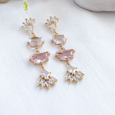 Wear this exquisite pink statement earrings to your wedding or any formal event and channel the glamorous art deco era. This art deco feature a unique arrangement of clear and light pink crystals that catch and reflect light from every angle, creating a mesmerizing play of shimmer and sparkle.The secure push back closure ensures that you can dance and mingle with confidence, knowing that your earrings will remain in place.✨Suggested occasion for wear: your wedding, wedding guest, bridal shower, Elegant Pink Crystal Bridal Earrings, Elegant Pink Chandelier Earrings For Formal Events, Elegant Pink Chandelier Earrings For Formal Occasions, Elegant Pink Cubic Zirconia Bridal Earrings, Elegant Pink Cubic Zirconia Earrings, Pink Crystal Jewelry For Evening, Formal Pink Crystal Earrings, Pink Cubic Zirconia Crystal Earrings For Party, Elegant Pink Jewelry For Evening