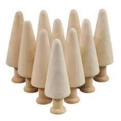 several wooden cones are lined up in a row on a white background, with one standing out from the crowd