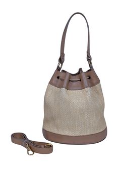 Introducing the must-have accessory of the summer, Furla's beige raffia bucket bag! Made with genuine leather trims, this stylish bag features a detachable long strap and drawstring closer. Perfect for pairing with a summer romper and wedge sandals, it's the ultimate on-trend statement piece. Raffia upper Genuine Leather trims and straps Suede lining Logo front Drawstring closure Detachable and adjustable long strap Staining on lining Height 9.5" Width 8.5" Depth 6" Handle drop 7" Strap drop 21" Raffia Bucket Bag, Stylish Bag, Leather Trims, Wedge Sandals, Bucket Bag, Genuine Leather, Wedges, Rompers, Sandals