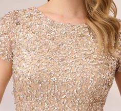 a woman wearing a dress with sequins on it