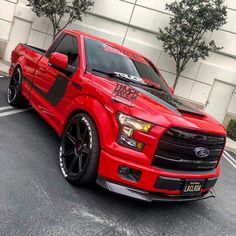 a red truck parked in a parking lot