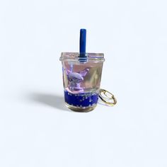 a small cup with a keychain attached to it