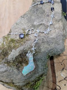 Ethiopian opal, Herkimer diamond & iolite choker. Perfect for summer as this stone looks like it has glitter inside. The glitter effect is visible in sunlight and especially indirect/indoor light. The opal also happens to be shaped like Florida 🙂 The choker is 14.5 inches with a 3 inch drop. It clasps in the front where there is a small iolite accent. The opal is hanging below a chain of Herkimer diamonds that extends up the chain and transitions to iolite. Opals are very difficult to photo Teardrop Ethiopian Opal Gemstone Jewelry, Opal Multi-stone Pendant Necklace, Silver Multi-stone Ethiopian Opal Jewelry, Unique Ethiopian Opal Gemstone Jewelry, Spiritual Opal Jewelry As A Gift, Handmade Opal Jewelry As A Gift, Handmade Opal Jewelry For Gift, Handmade Opal Jewelry Gift, Opal Teardrop Jewelry With Natural Stones