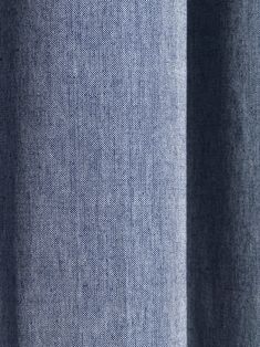 a close up view of the fabric on a blue shirting material, which is slightly visible