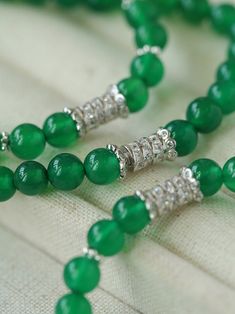 This elastic necklace combines traditional Chinese aesthetic elements with modern style. Featuring sparkling zirconia beads and soothing green agate beads, this necklace exudes elegance and sophistication. The intricate bead arrangement creates a harmonious balance between vintage charm and modern style. Metal: Recycled Sterling Silver Gemstone: Cubic Zirconia,Green Onyx Diameter: Long 760mm,Short 440mm Weight: Long 42g,Short 24g