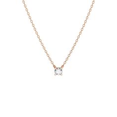 a gold necklace with a small white diamond