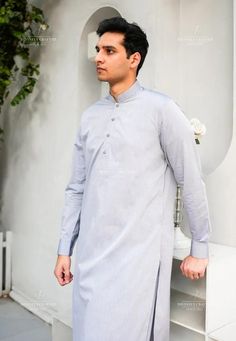 Classic Gray Men's Shalwar Kameez | Elegant and Timeless Elevate your wardrobe with our classic Gray Men's Shalwar Kameez, a perfect blend of tradition and modern style. This versatile outfit is crafted from high-quality, breathable fabric, ensuring comfort and durability. The Gray color adds a touch of sophistication, making it ideal for both casual and formal occasions. The kameez features a tailored fit with a straight cut, enhancing the traditional look while offering a contemporary silhouet Semi-formal Long Sleeve Traditional Wear For Eid, Festive Semi-formal Cotton Traditional Wear, Semi-formal Long Sleeve Kurta For Eid, Classic Cotton Kurta For Semi-formal Occasions, Semi-formal Cotton Traditional Wear, Elegant Cotton Kurta For Semi-formal Occasions, Formal Cotton Salwar Kameez With Dabka Detailing, Classic Unstitched Suit For Eid, Classic Unstitched Suit For Eid Semi-formal