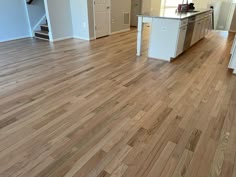 an empty kitchen and living room with hard wood flooring on the hardwood in this home